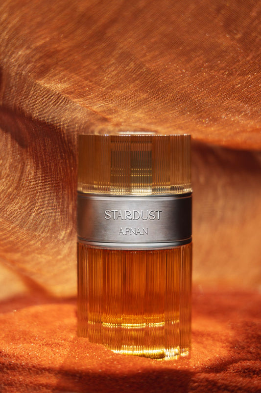 Afnan Stardust Extrait de Parfum 100 ml, flacone scanalato color ambra con fascia metallica
